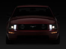 Load image into Gallery viewer, Raxiom 05-09 Ford Mustang w/ Halogen Prjctor Headlights- Black Housing (Clear Lens) (No GT500 )