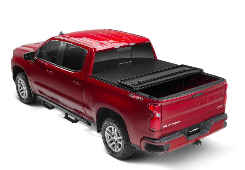 Lund 04-15 Nissan Titan (5.5ft. Bed) Hard Fold Tonneau Cover w/Bracket Kit - Black